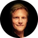 Sam Demma A person with short blond hair and fair skin smiles slightly, facing the camera against a dark background in a circular frame—showcasing the confidence gained through Elite Speaker Coaching with Sam Demma. Elite Speaker Coaching