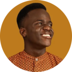 Sam Demma A person with short hair and a patterned shirt smiles while looking to the side, set against a solid mustard yellow background—capturing the confident energy of an Elite Speaker Coaching session with Sam Demma. Elite Speaker Coaching