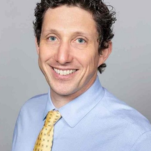 Sam Demma Sam Demma, founder of Elite Speaker Coaching, smiles at the camera with his curly brown hair, wearing a light blue dress shirt and yellow patterned tie against a plain light background. Elite Speaker Coaching